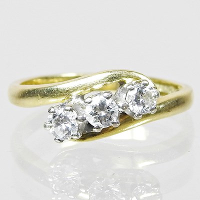 Lot 292 - An 18 carat gold and diamond three stone ring,...