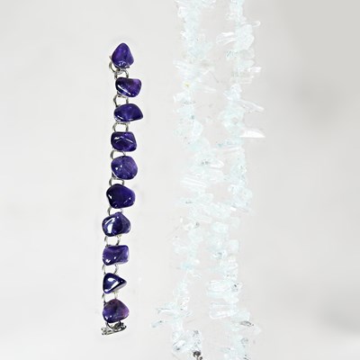 Lot 258 - A natural quartz bead bracelet, together with...