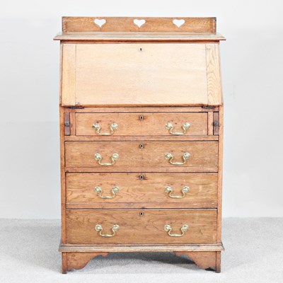 Lot 175 - An Arts and Crafts oak bureau, with a heart...