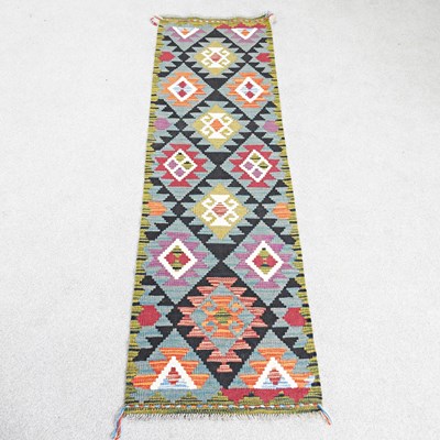 Lot 81 - A kilim runner, with all over coloured...