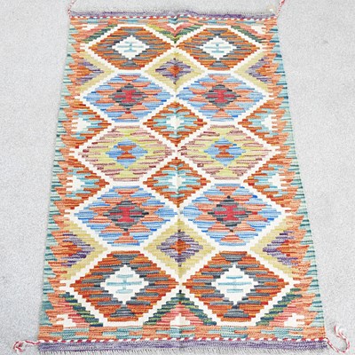 Lot 14 - A kilim rug, with two rows of coloured...