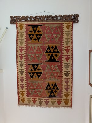 Lot 585 - A kilim flatweave wall hanging, on a carved...