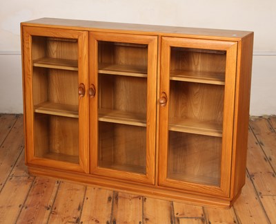Lot 288 - A mid century Ercol elm triple...