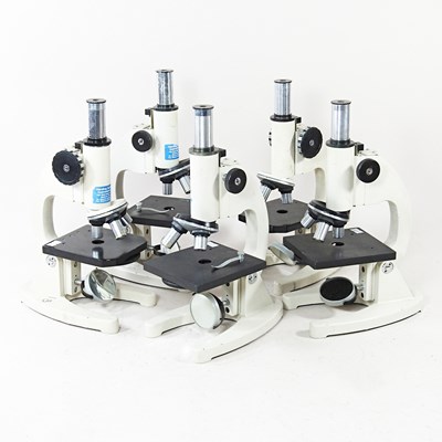 Lot 555 - A collection of five student's microscopes,...