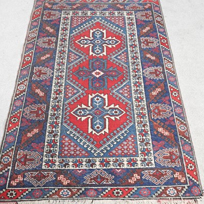 Lot 127 - A Turkish woollen rug, with three central...