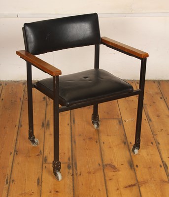 Lot 557 - An unusual black upholstered armchair, having...
