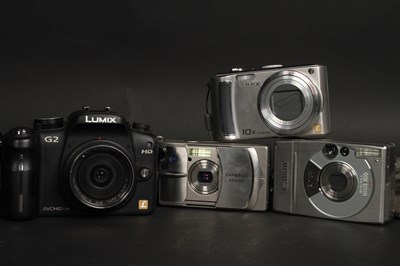 Lot 676 - Four cameras and a Canon camcorder, one in...