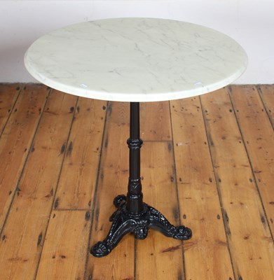 Lot 607 - A cast iron marble topped circular cafe table...