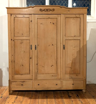 Lot 543 - A pine triple wardrobe, h.204cm, w.186cm, d.65cm