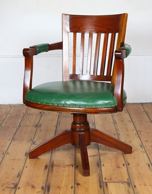 Lot 477 - A mahogany swivel desk chair, having a green seat