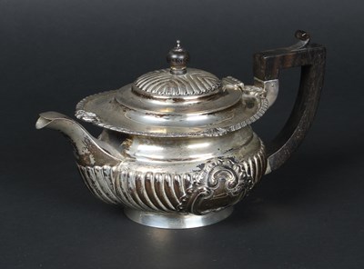 Lot 42 - A Victorian silver teapot, half gadrooned,...