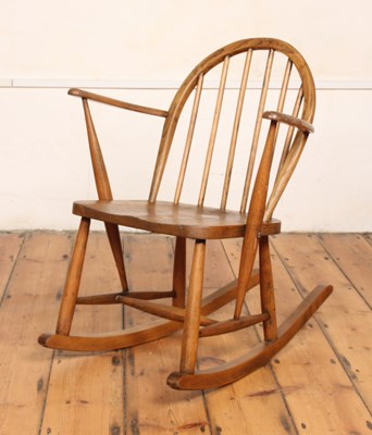Lot 584 - An Ercol style elm child's rocking chair
