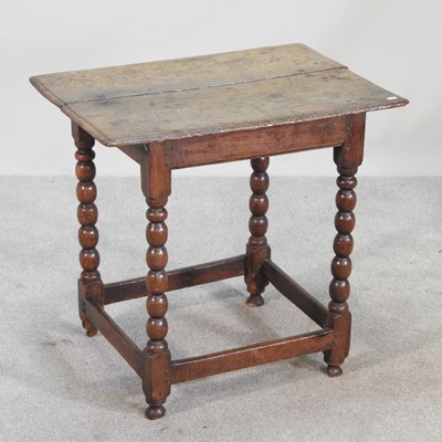 Lot 374 - An 18th century oak side table, on bobbin...