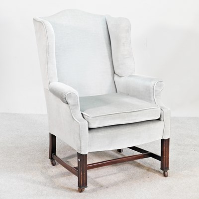 Lot 655 - A Georgian style green upholstered wing...
