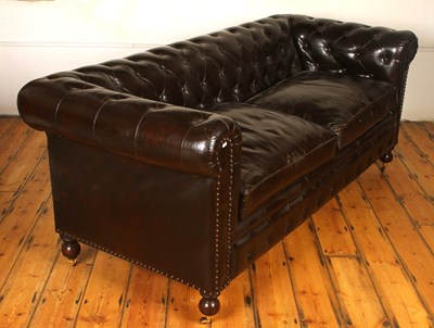 Lot 635 - A brown leather button upholstered...