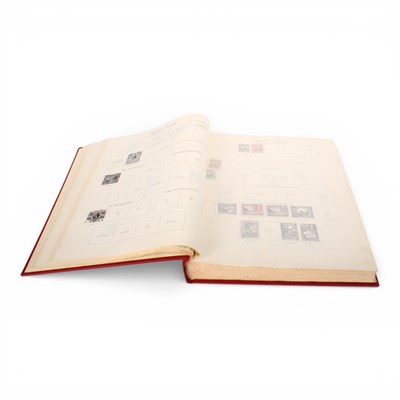 Lot 131 - A red New Ideal stamp album, up to the mid...
