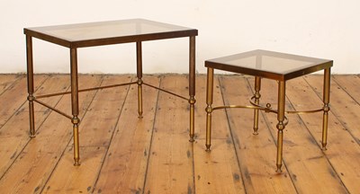 Lot 506 - A nest of two brass and smoky glass occasional...