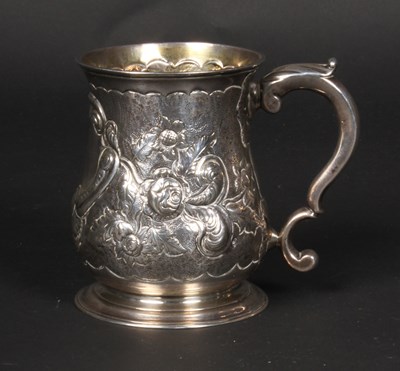 Lot 37 - A George II silver mug, repousse decorated...
