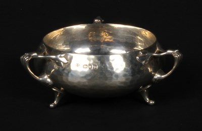 Lot 50 - An Arts and Crafts silver three handled bowl,...