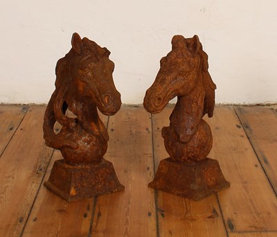 Lot 572 - A pair of rusted cast iron horse head gate...