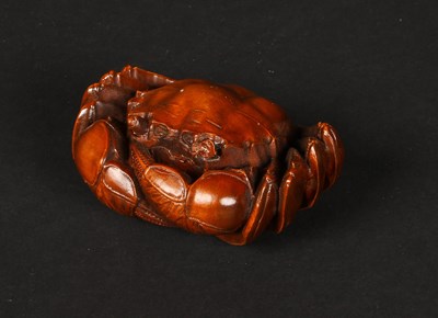 Lot 146 - A small Japanese carved wooden okimono, in the...