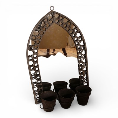 Lot 723 - A metal arched garden wall mirror, having...