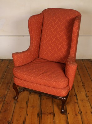Lot 531 - A red upholstered wing back armchair