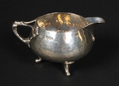 Lot 45 - An Arts and Crafts silver milk jug, having...