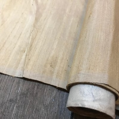 Lot 222 - A part roll of gold coloured silk fabric