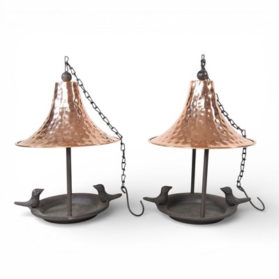 Lot 569 - A pair of metal bird feeders, with copper...