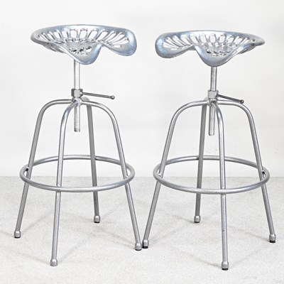 Lot 141 - A pair of revolving tractor seat bar stools (2)