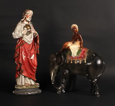 Lot 669 - A vintage plaster model of a child riding an...