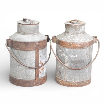 Lot 562 - Two metal churns, each with a swing handle,...