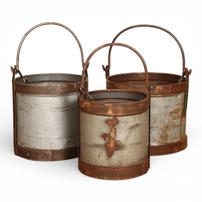 Lot 556 - A set of three graduated metal milk buckets