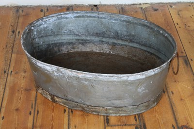 Lot 598 - A large galvanised metal oval planter, with...