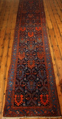 Lot 497 - A Persian runner, on a blue ground within...
