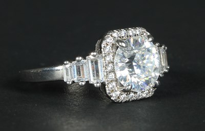 Lot 52 - An 18 carat white gold cluster ring, the...