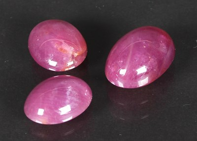 Lot 85 - Three loose ruby stones, oval cabochon cut,...