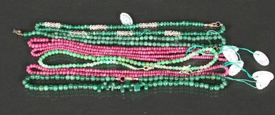 Lot 49 - A collection of ruby and emerald single strand...
