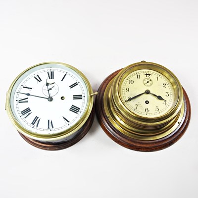 Lot 57 - A brass cased ship's clock, mounted on a...