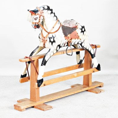 Lot 4 - A painted wooden rocking horse, on a wooden...