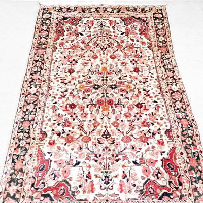 Lot 392 - A Persian rug, with foliate and floral designs,...