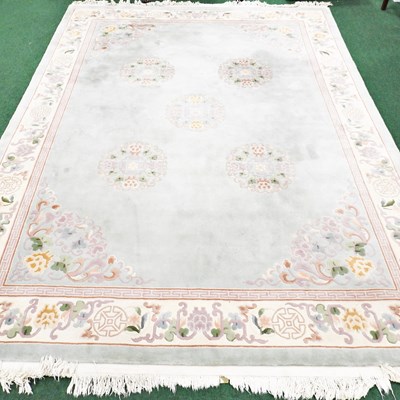 Lot 449 - A large Chinese woollen carpet, decorated with...