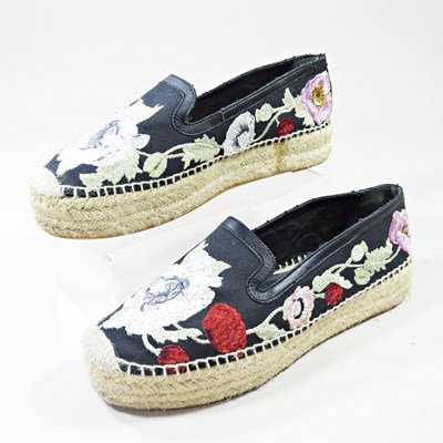 Lot 496 - A pair of embroidered moccasin shoes, by...