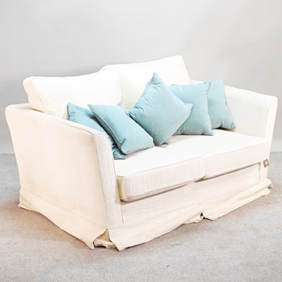 Lot 134 - A modern cream upholstered two seater sofa,...