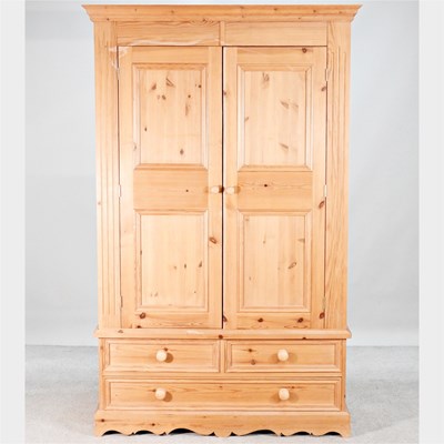 Lot 237 - A modern pine double wardrobe, with drawers below