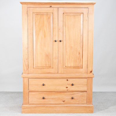 Lot 145 - A modern iroko hardwood double wardrobe, with...