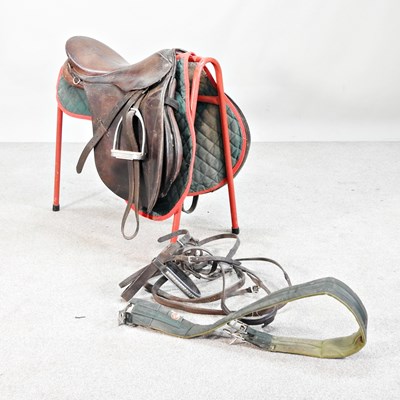 Lot 573 - A leather horse's saddle, on stand