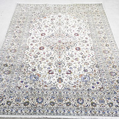 Lot 505 - A Persian kashan carpet, with scrolling...