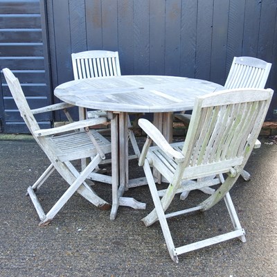 Lot 311 - A wooden circular garden table, 121cm wide,...